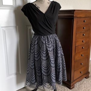 Cocktail dress. Black with silver sparkles throughout skirt.